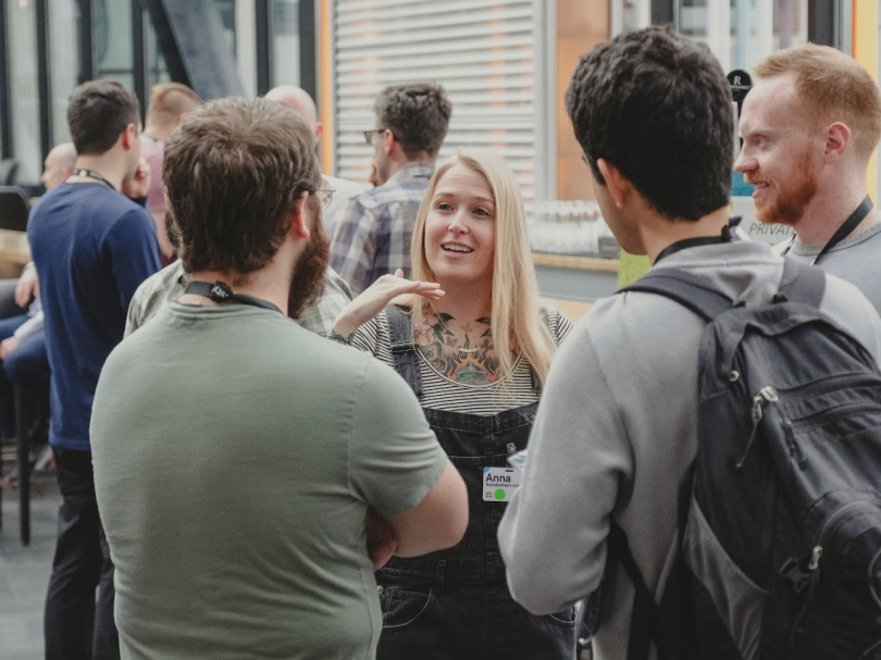 Four Doximity team members chat together during the annual Doximity Conference